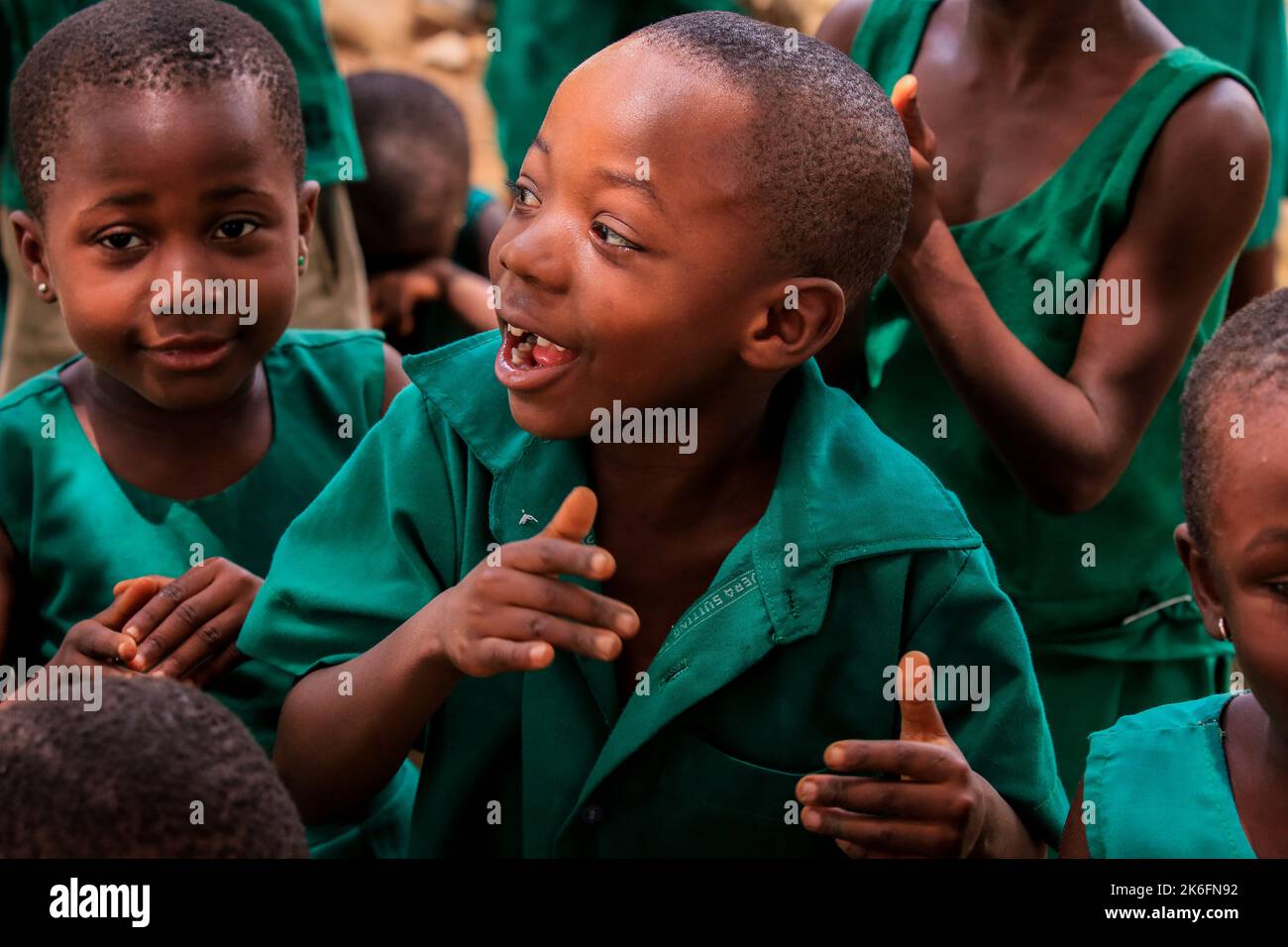 Amedzofe, Ghana - April 07, 2022: African Pupils in Colorful School Uniform near the small Ghana Amedzofe town Stock Photo