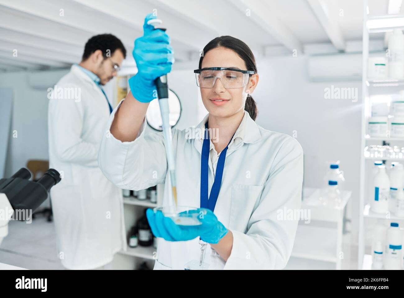 Carrying out routine lab tasks. a young scientist working with samples