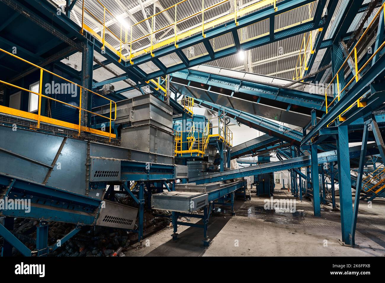 Large production line with conveyors carrying trash at plant Stock Photo
