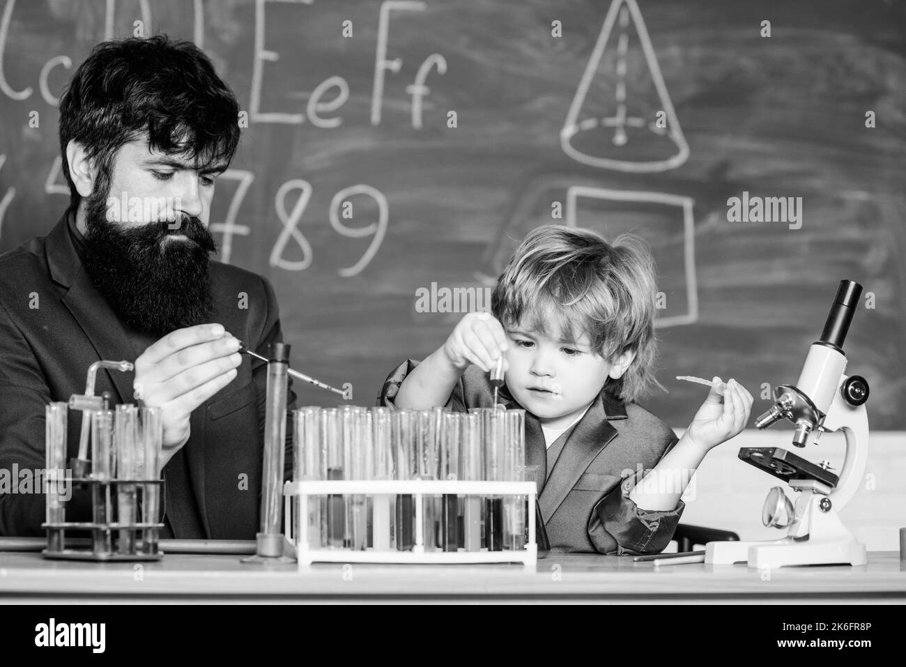 biology and chemistry education. father and son at school. Educational concept. Back to school. teacher man with little boy. School education. Dream Stock Photo