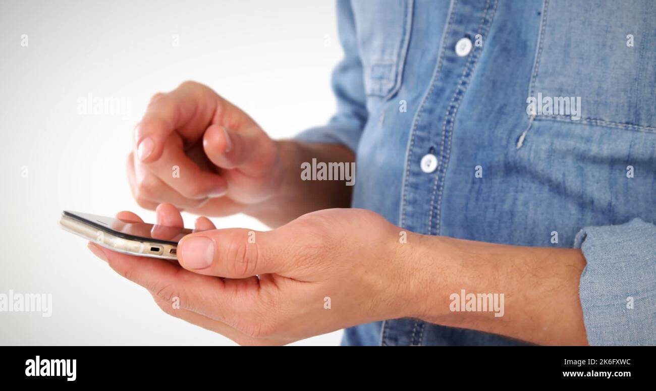 Midsection of caucasian man using cellphone against white background, copy space Stock Photo