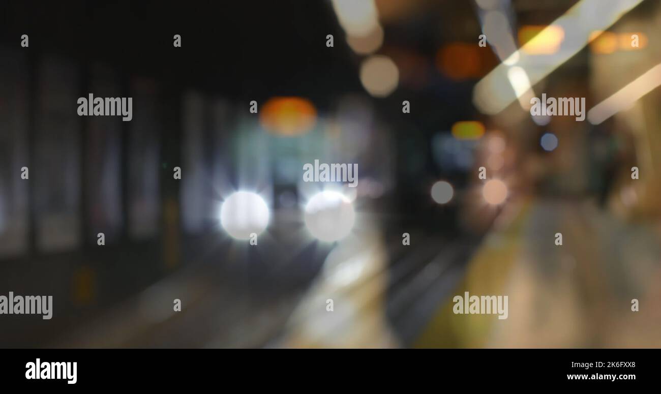 Defocused image of lens flares and moving train at subway station, copy space Stock Photo
