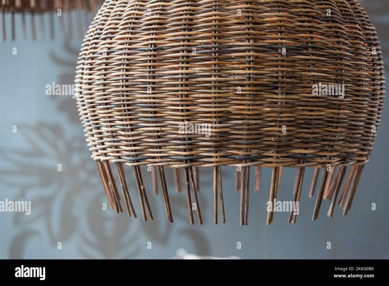 Detail of a basket lamp hanging from the ceiling from side perspective Stock Photo