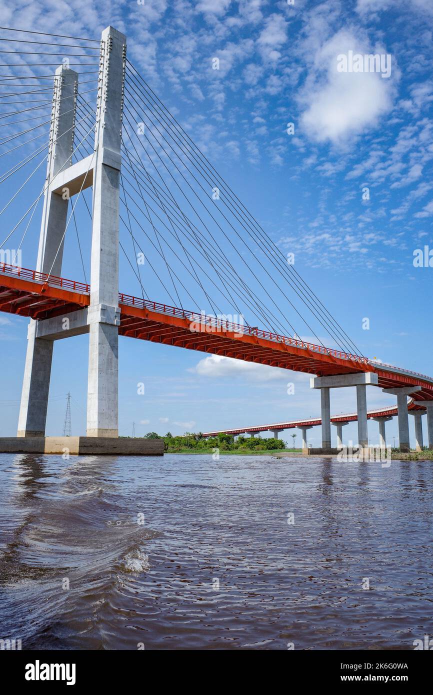 A suspension bridge spanning the Amazon river near Iquitos, Peru Stock Photo