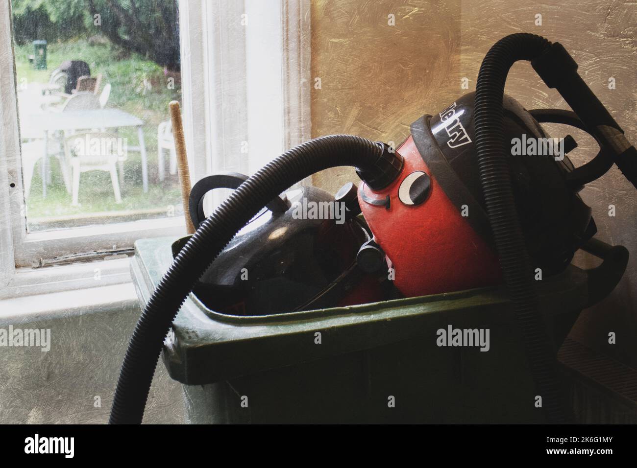 Vacuum cleaners left in a bin Stock Photo