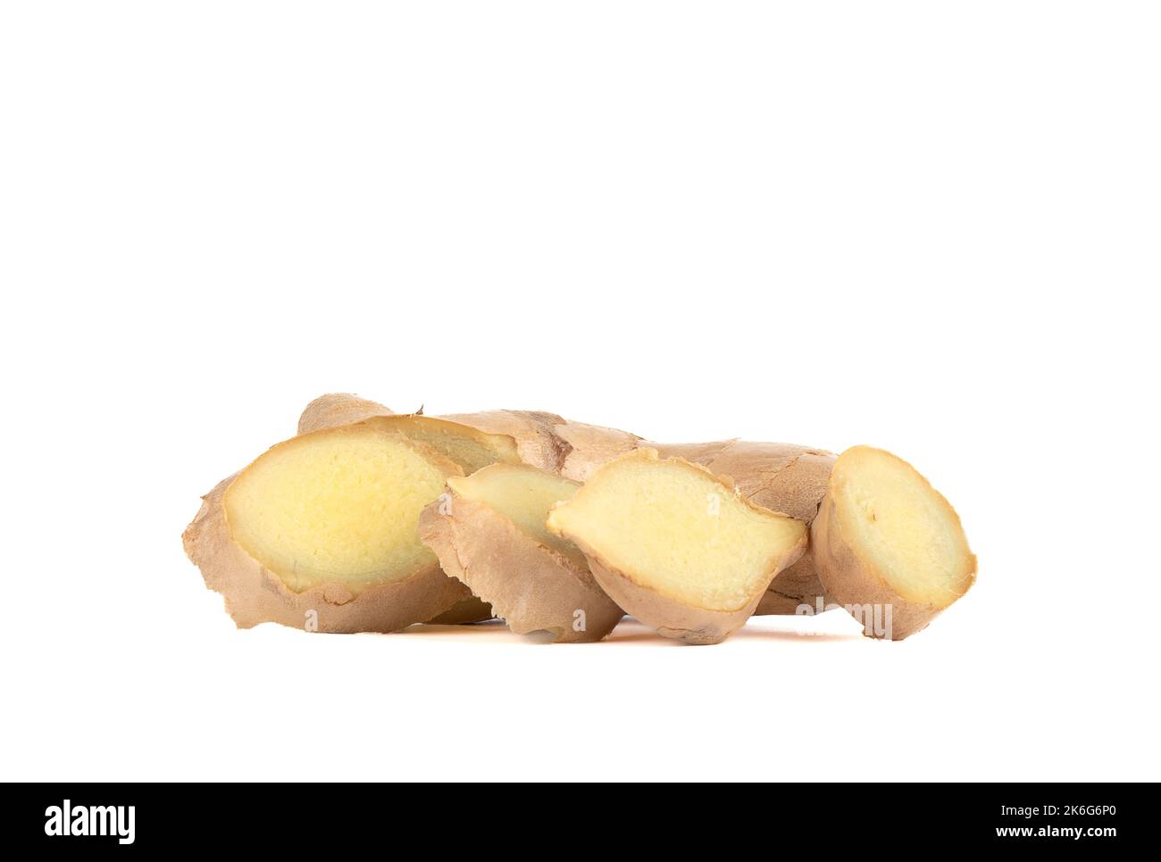 Ginger root with pieces cut off from it on a white background. Copy space. Stock Photo
