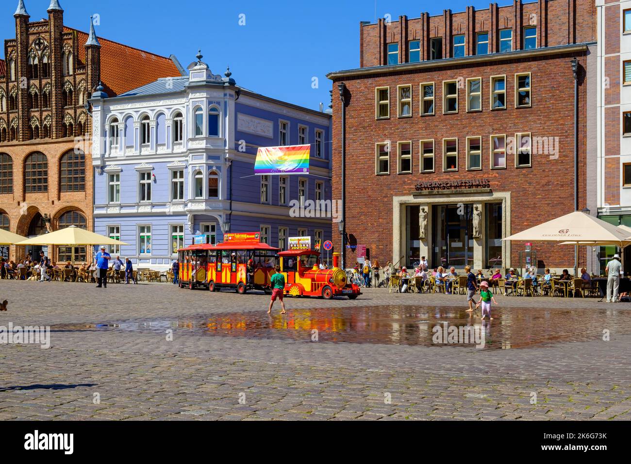 Summer tourist scene typical for the vacation season on the Old Market Square, Hanseatic Town of Stralsund, Mecklenburg-Western Pomerania, Germany. Stock Photo