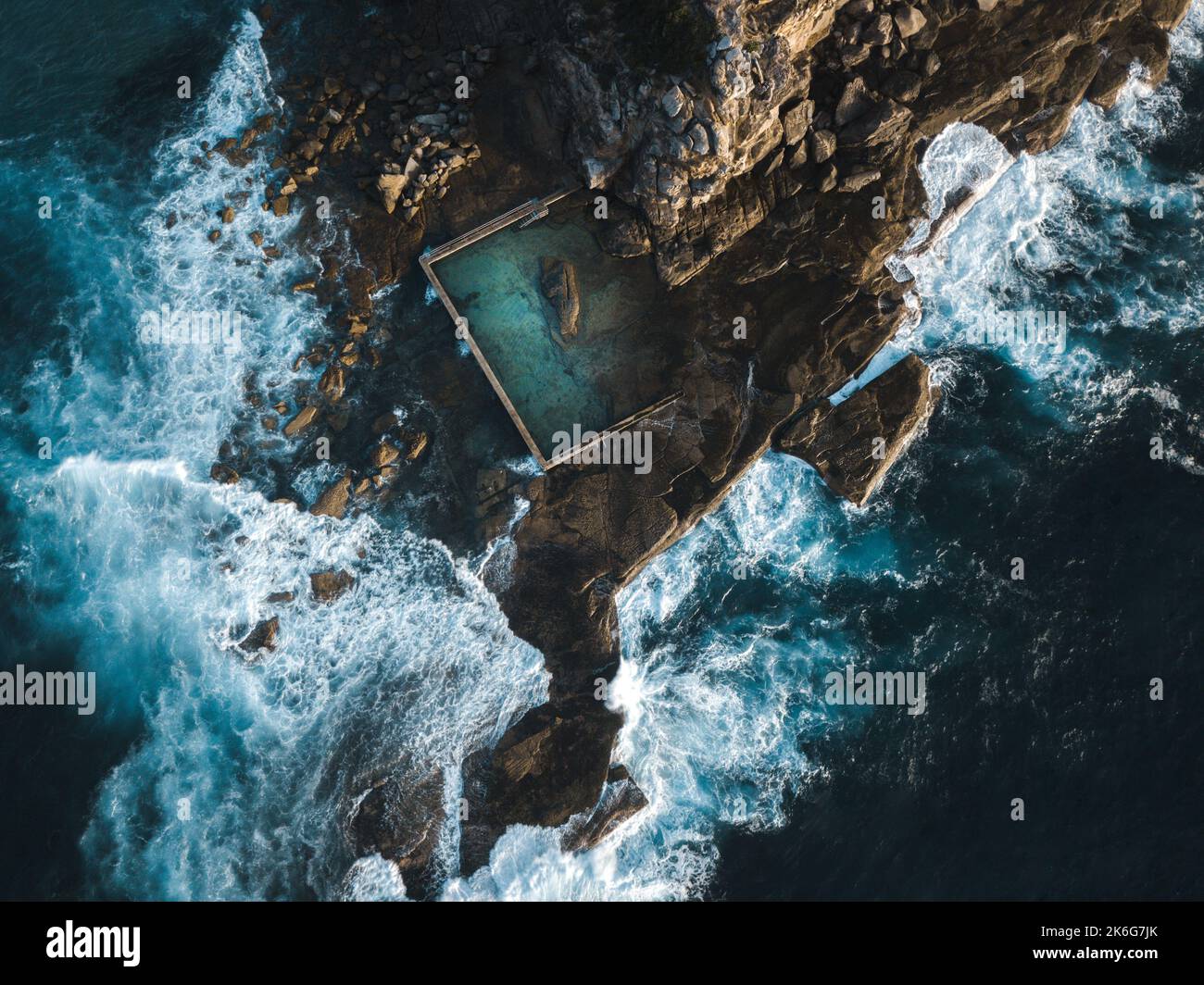 Curl Curl Ocean Rock Pool built into the side of a cliff aerial view Stock Photo