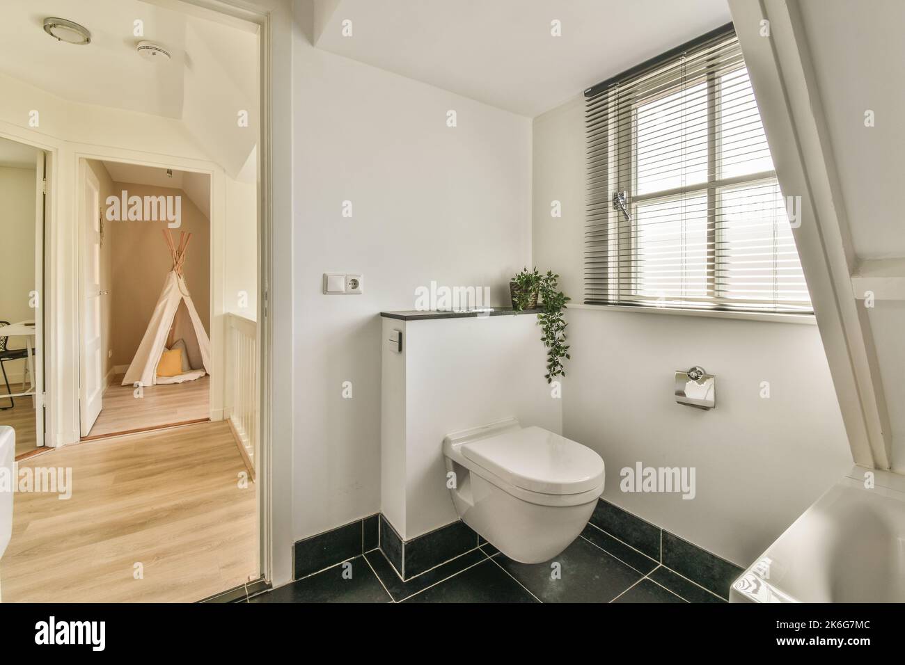 Sink base cabinet and mirror cabinet in white tiled bathroom with wall ...