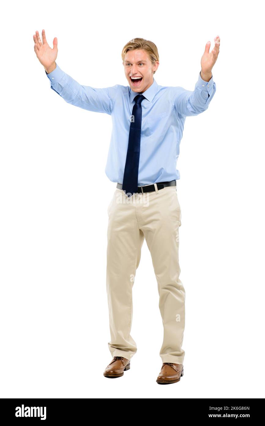 This is amazing. Full length shot of a handsome young businessman standing alone in the studio and celebrating. Stock Photo