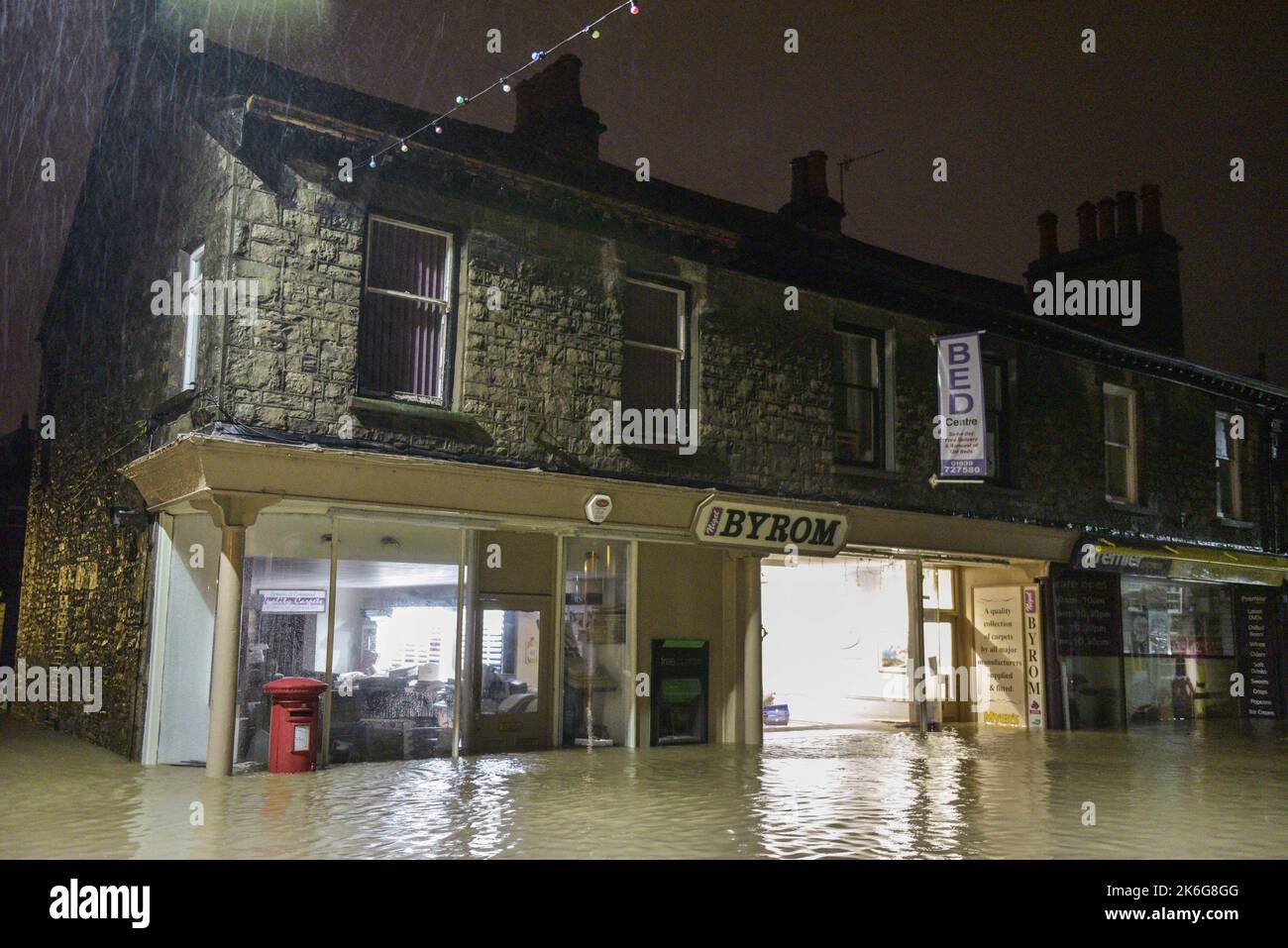 Kendal, Cumbria - December 6th 2015 - A row of shops and a post box flooded in Kendal, Cumbria in the early hours of the 6th of December 2015 after 36 hours of torrential rain during Storm Desmond. Pic Credit: Scott CM/Alamy Live News Stock Photo