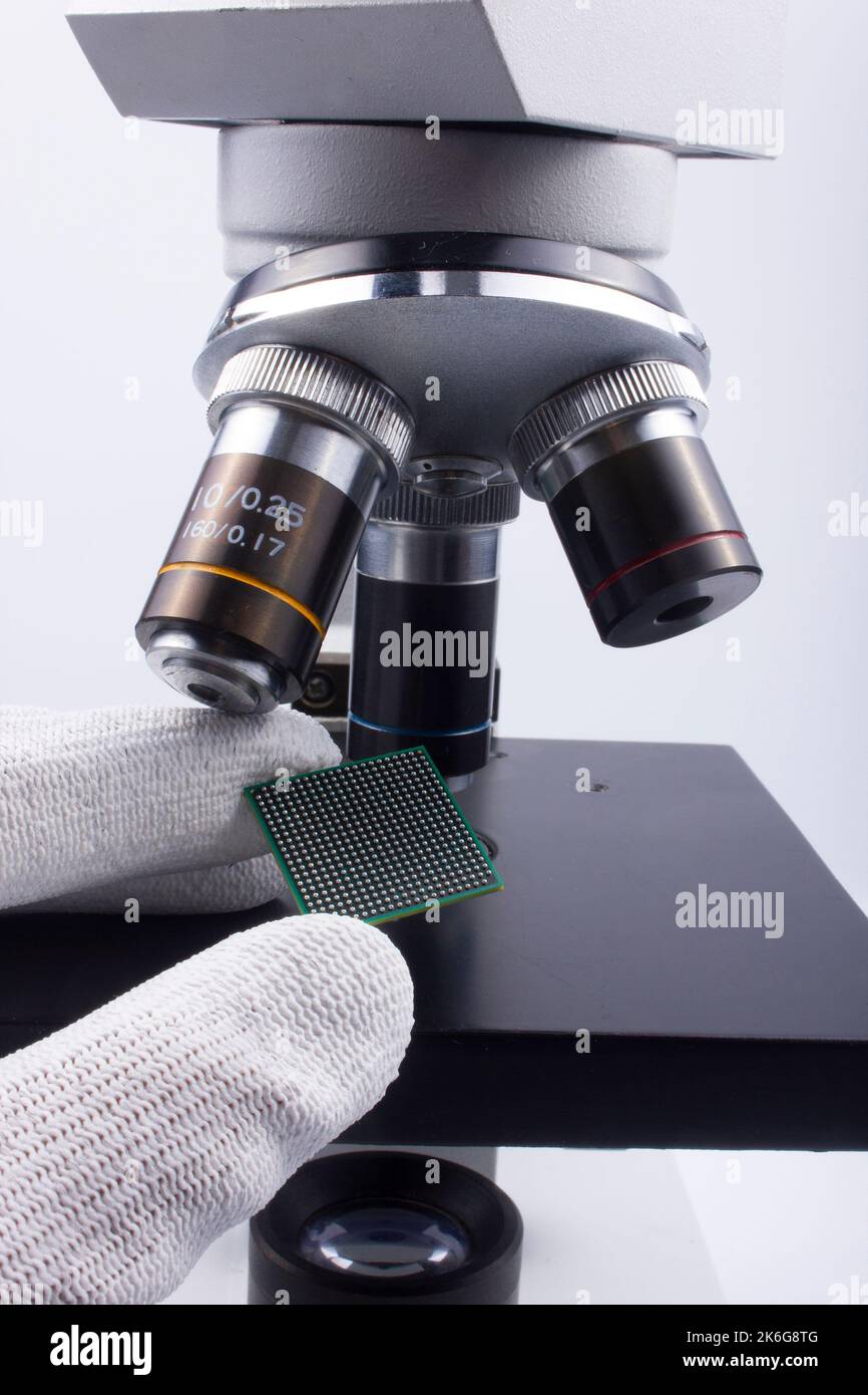 Semiconductor BGA chip in fingers and optical microscope IC inspection Stock Photo Alamy