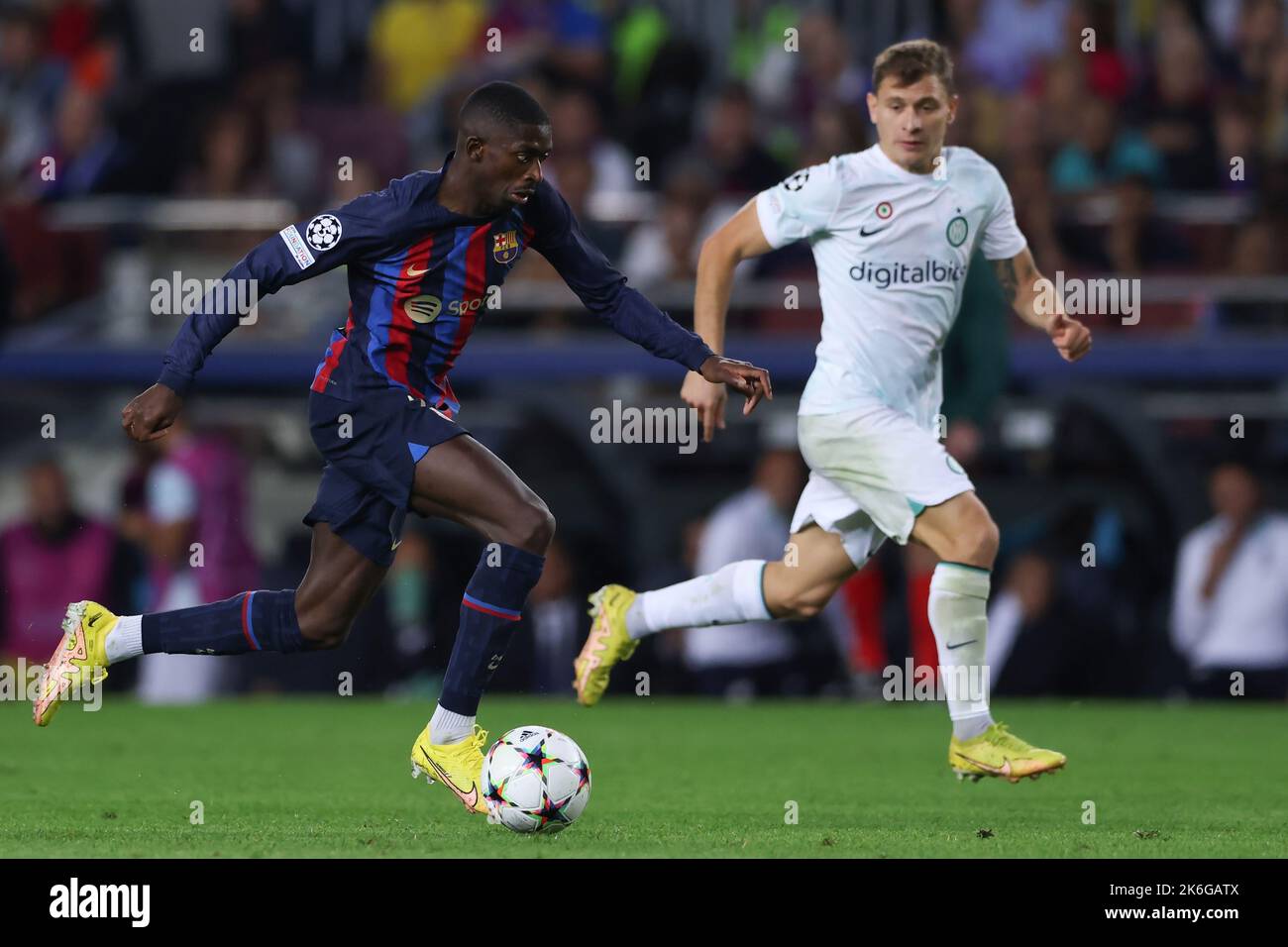 Barcelona, Spain, 12th October 2022. Ousmane Dembele of FC Barcelona is pursued by Nicolo Barella of FC Internazionale as he breaks with the ball during the UEFA Champions League match at Camp Nou, Barcelona. Picture credit should read: Jonathan Moscrop / Sportimage Stock Photo