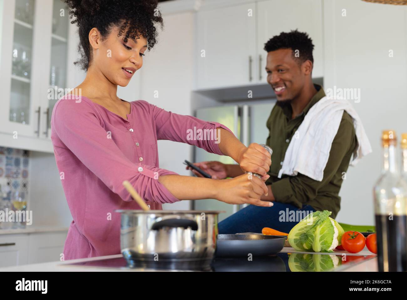 Happy african american couple cooking dinner together in kitchen Stock ...