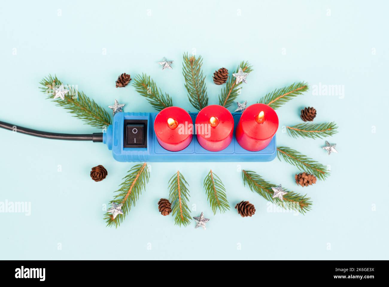 Red christmas candles in a socket, expensive electricity costs, blackout risk in Germany, cold winter with rationing Stock Photo