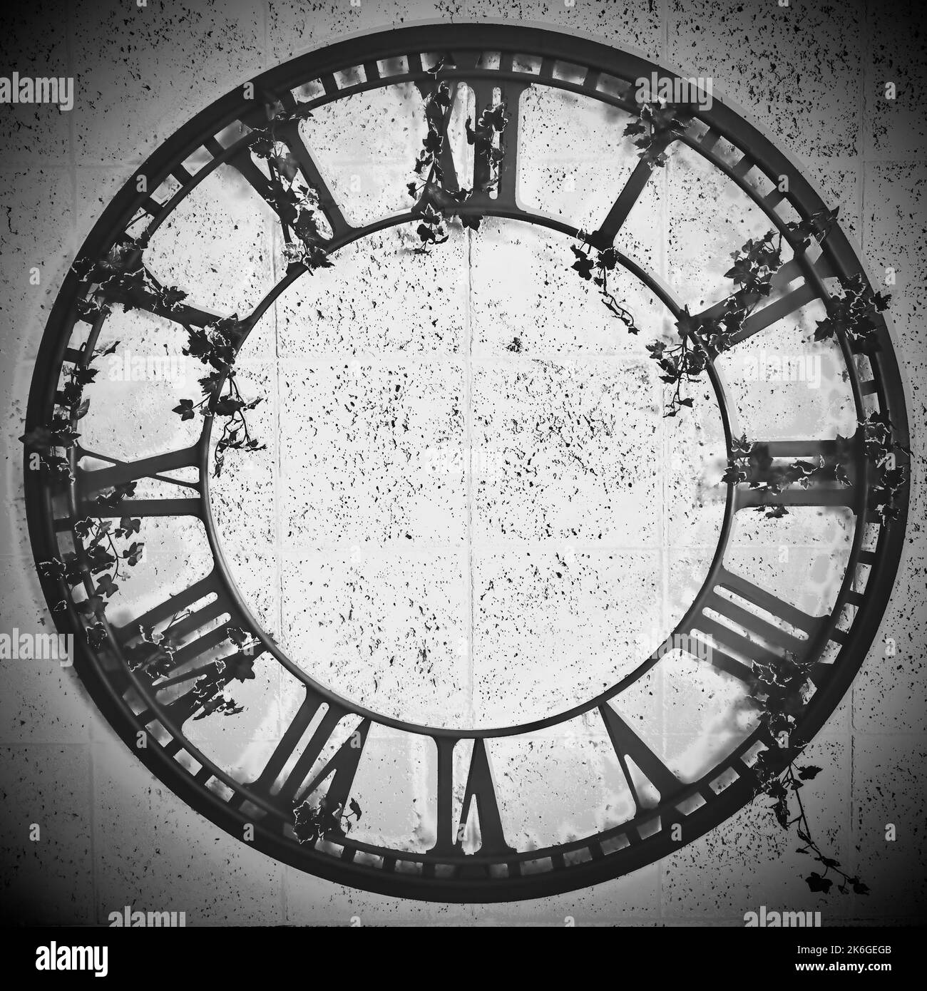 A vintage old clock with roman numerals and no hands Stock Photo Alamy