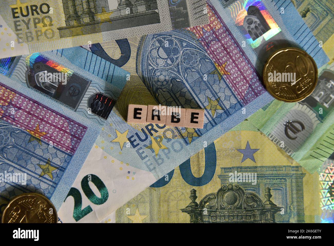 the german word for heritage with wodden cubes and euro bills Stock Photo