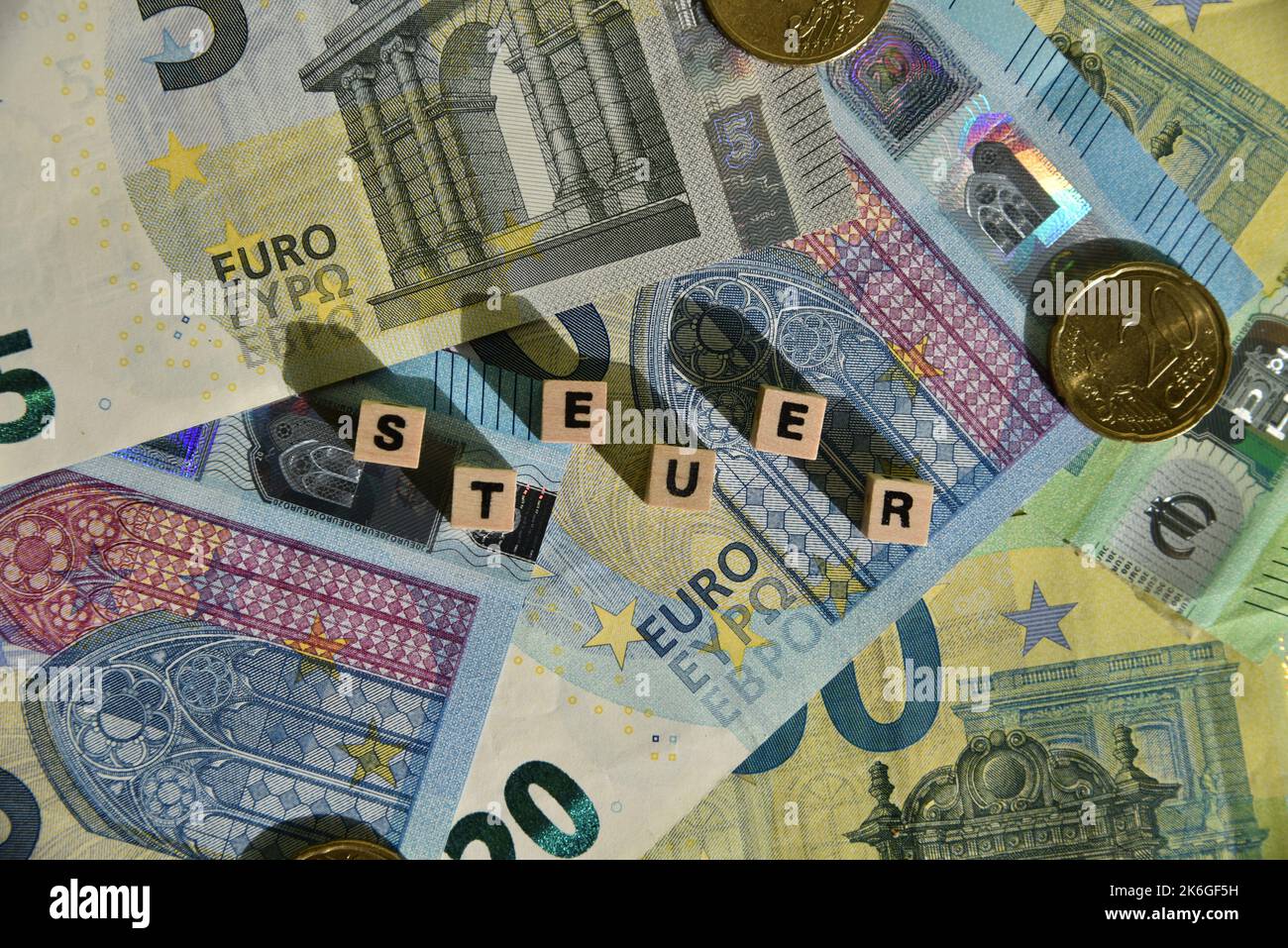 the german word for tax with wodden cubes and euro bills Stock Photo