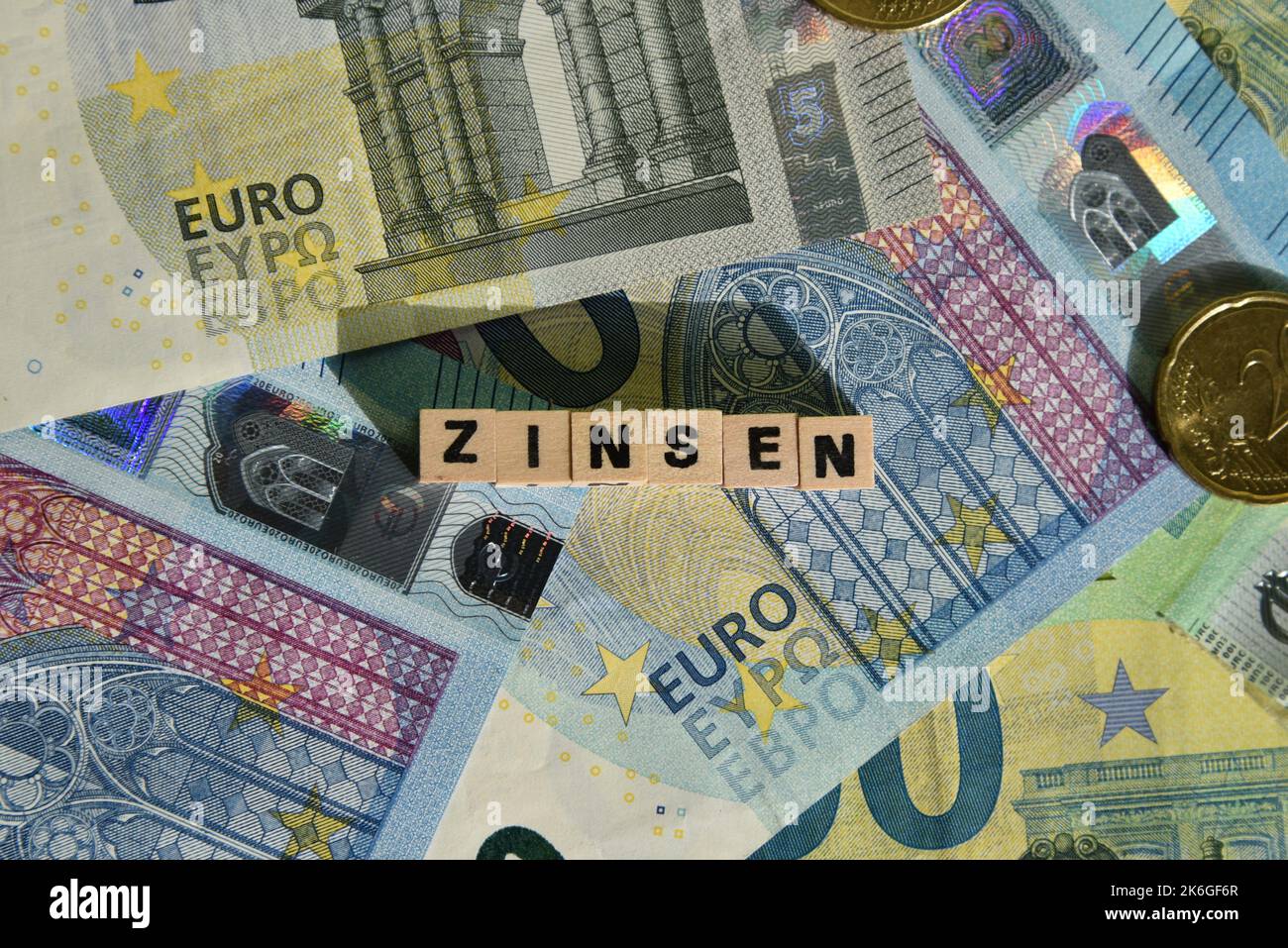 the german word for interest with wodden cubes and euro bills Stock Photo