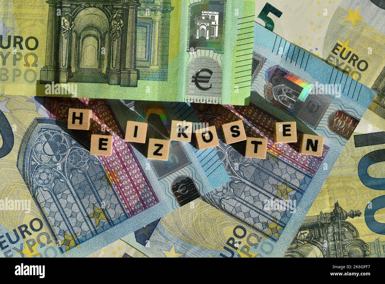 the german word for heating costs with wodden cubes and euro bills Stock Photo