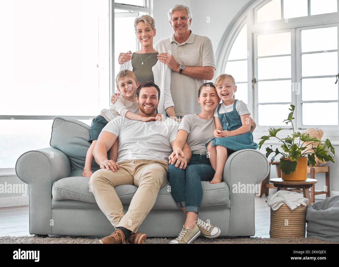 All happy families are alike. a happy family relaxing on the sofa at home. Stock Photo