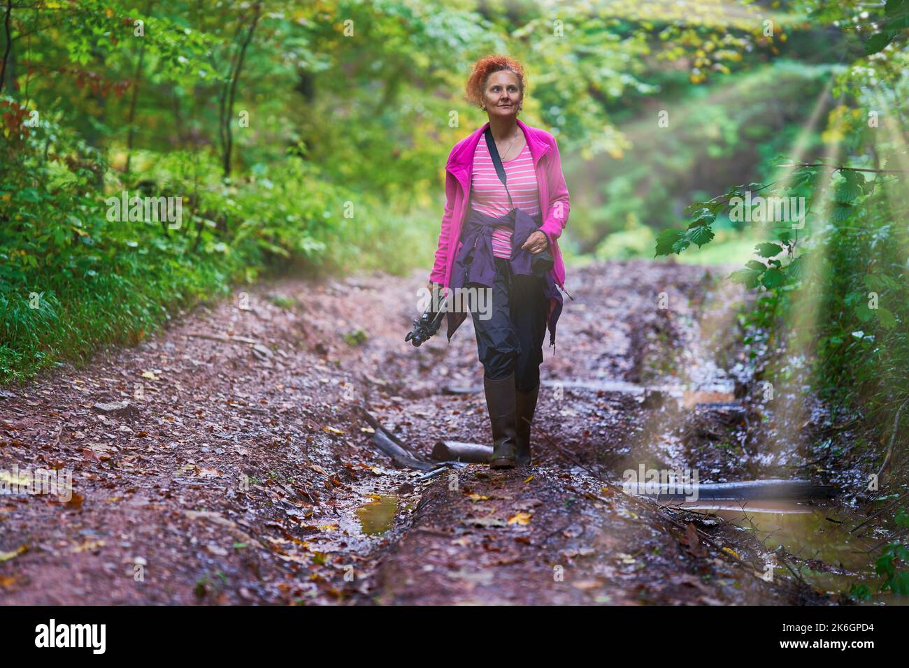 Woman with curly hair, nature photographer, hiking in the mountain ...