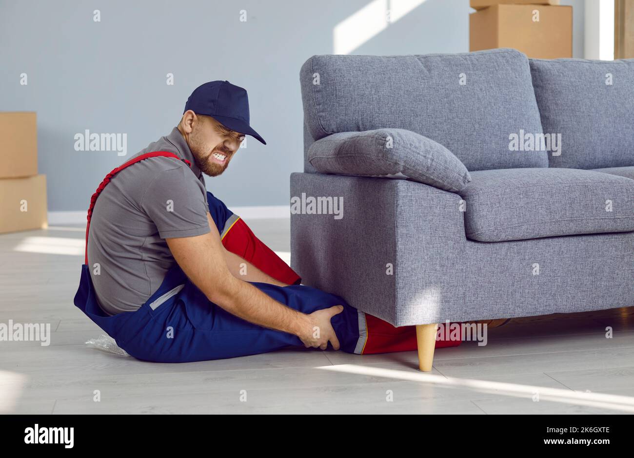 While lifting heavy furniture, young worker got his leg pinned under