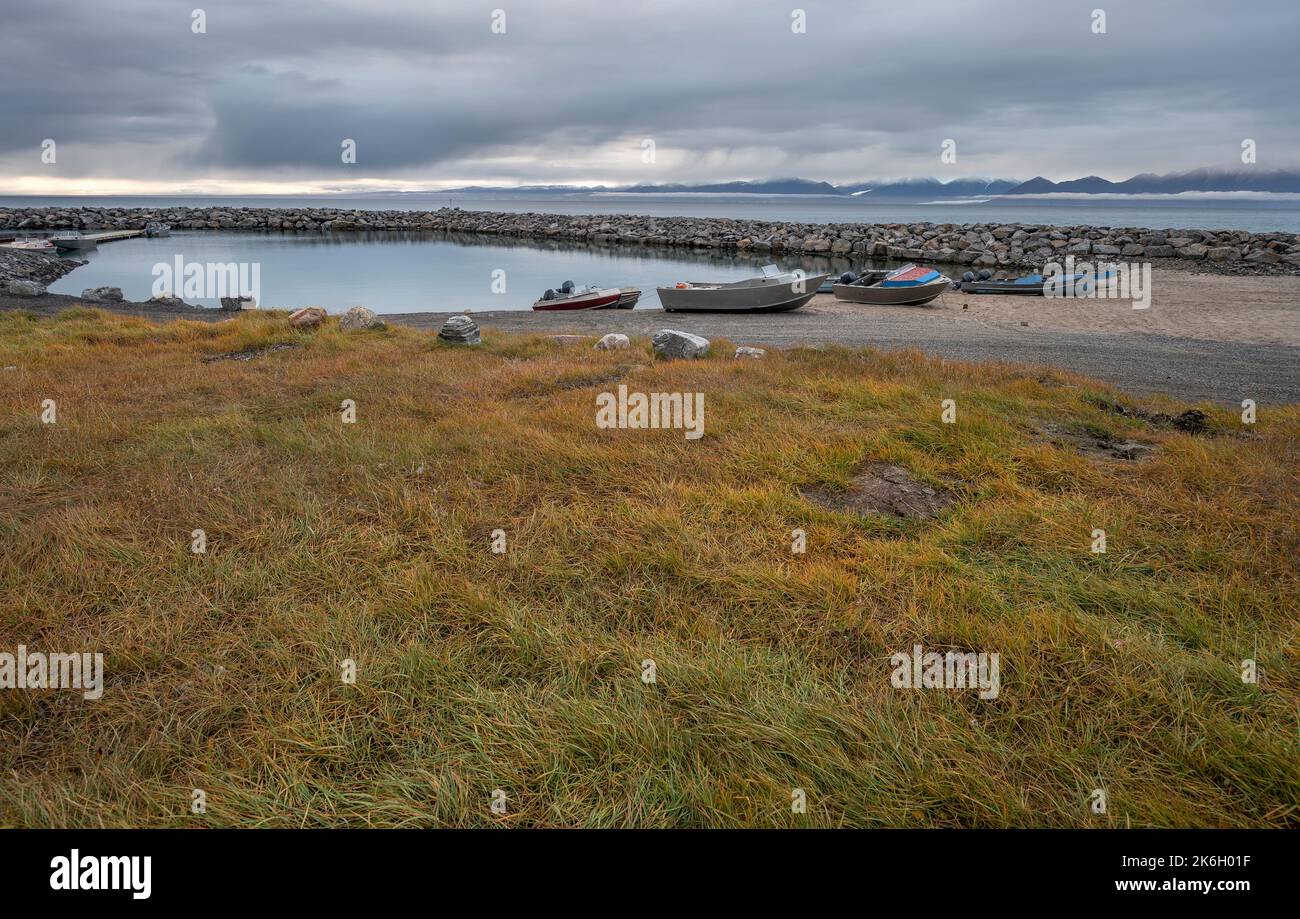 Fishing boats at the Artic Ocean harbor at Pond Inlet with the Byam ...