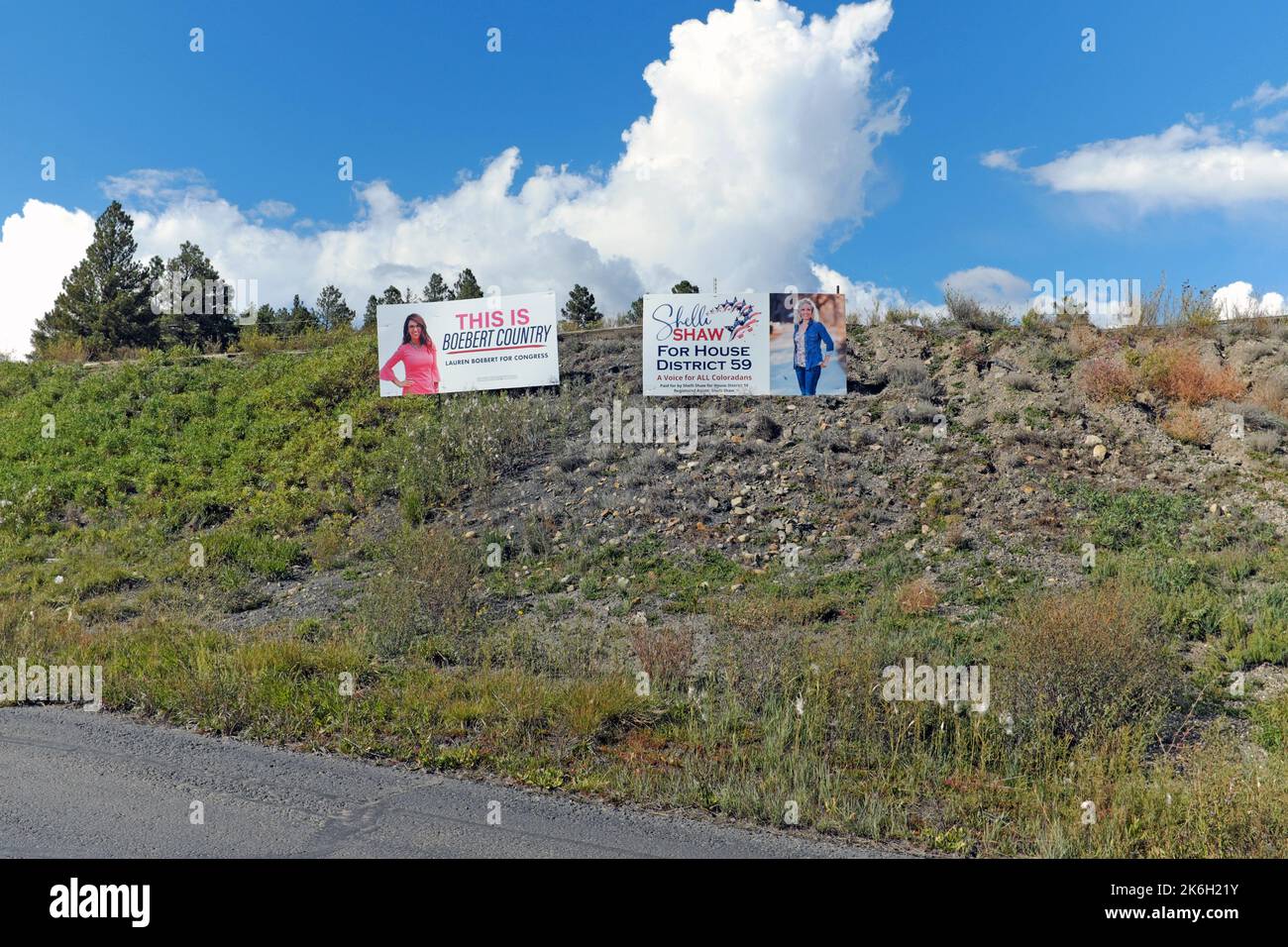 Two political billboards sit on a ridge along US Highway 160 in conservative Pagosa Springs, Colorado, promote Lauren Opal Boebert and Shelli Shaw. Stock Photo