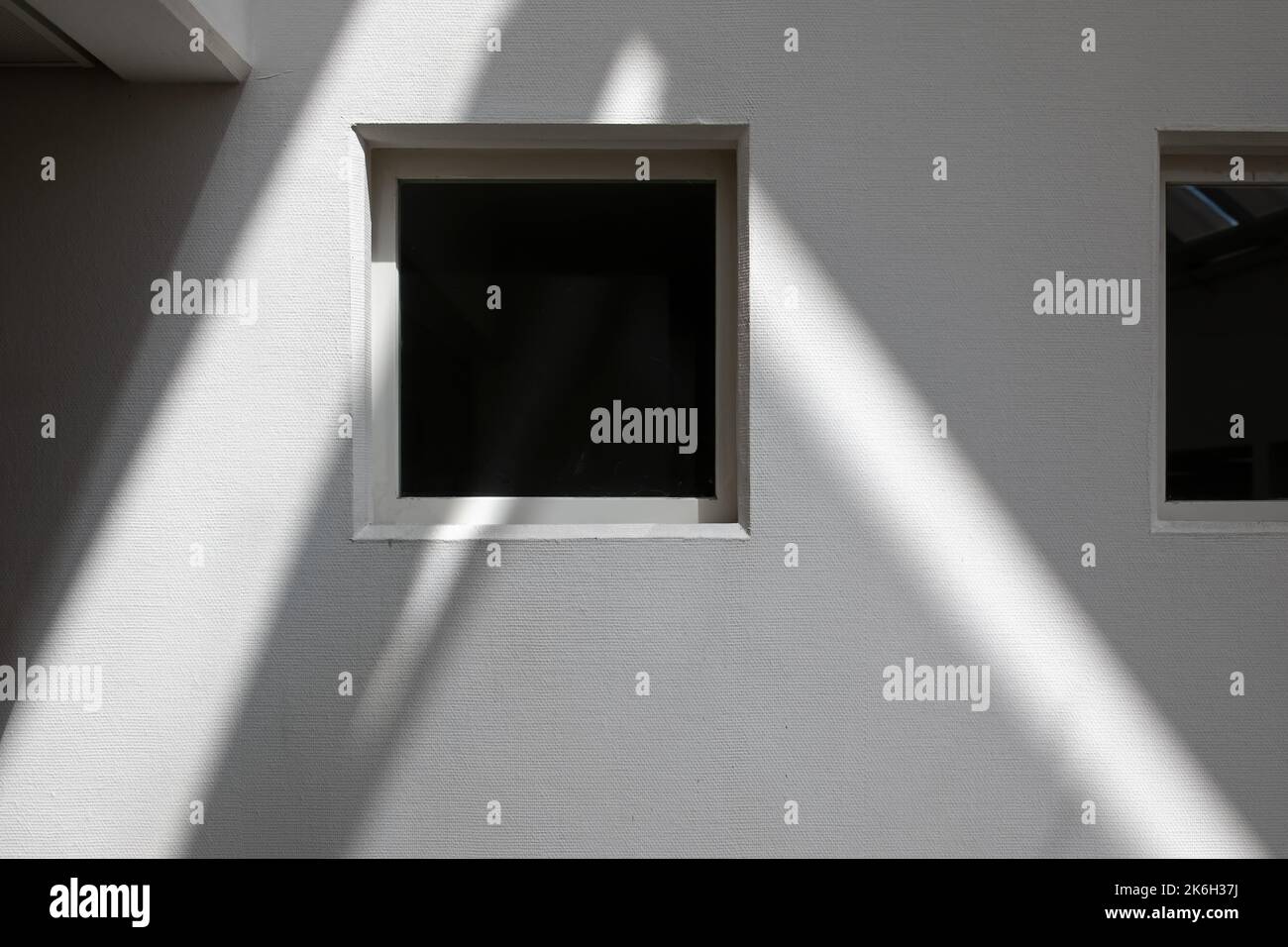 window with rays of light on a white wall and shadows Stock Photo - Alamy