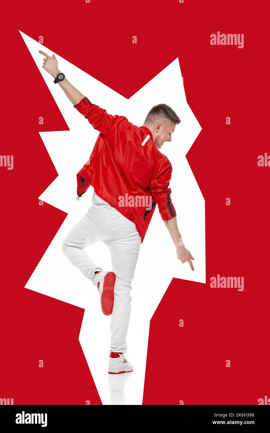young man in denim clothes jumping and dancing . Stock Photo