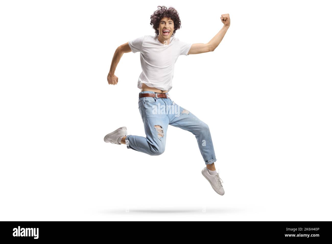 Casual young man jumping with happiness isolated on white background Stock Photo