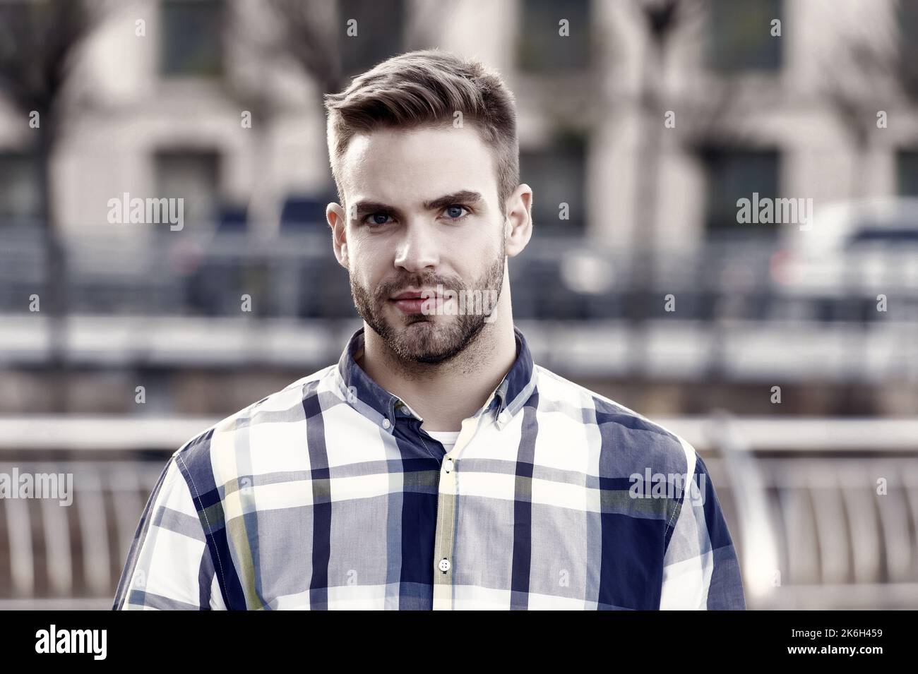 Theres no doubting he looks good. Unshaven man urban outdoors. Handsome