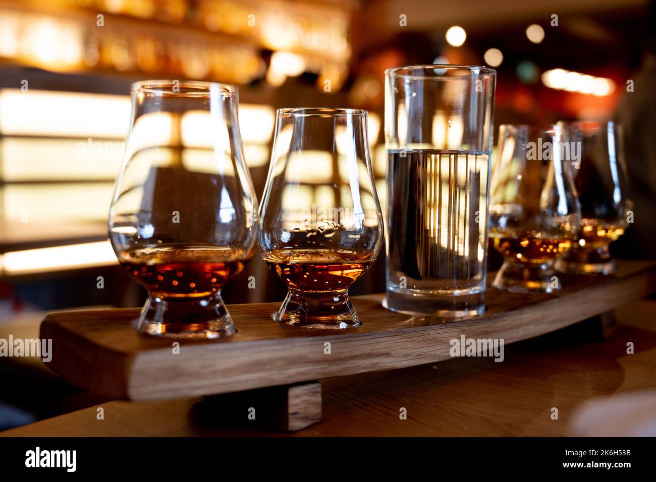 Flight of single malt scotch whisky in glasses served in bar in ...