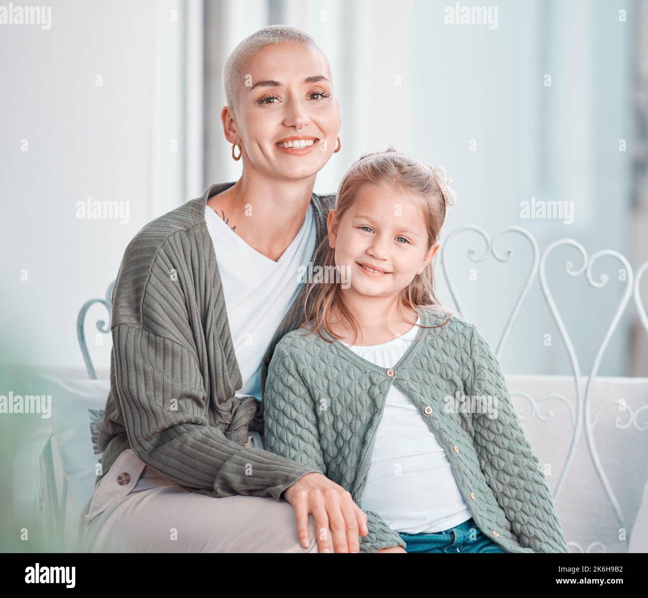 Mom and adorable daughter smiling at the camera. Portrait of little ...