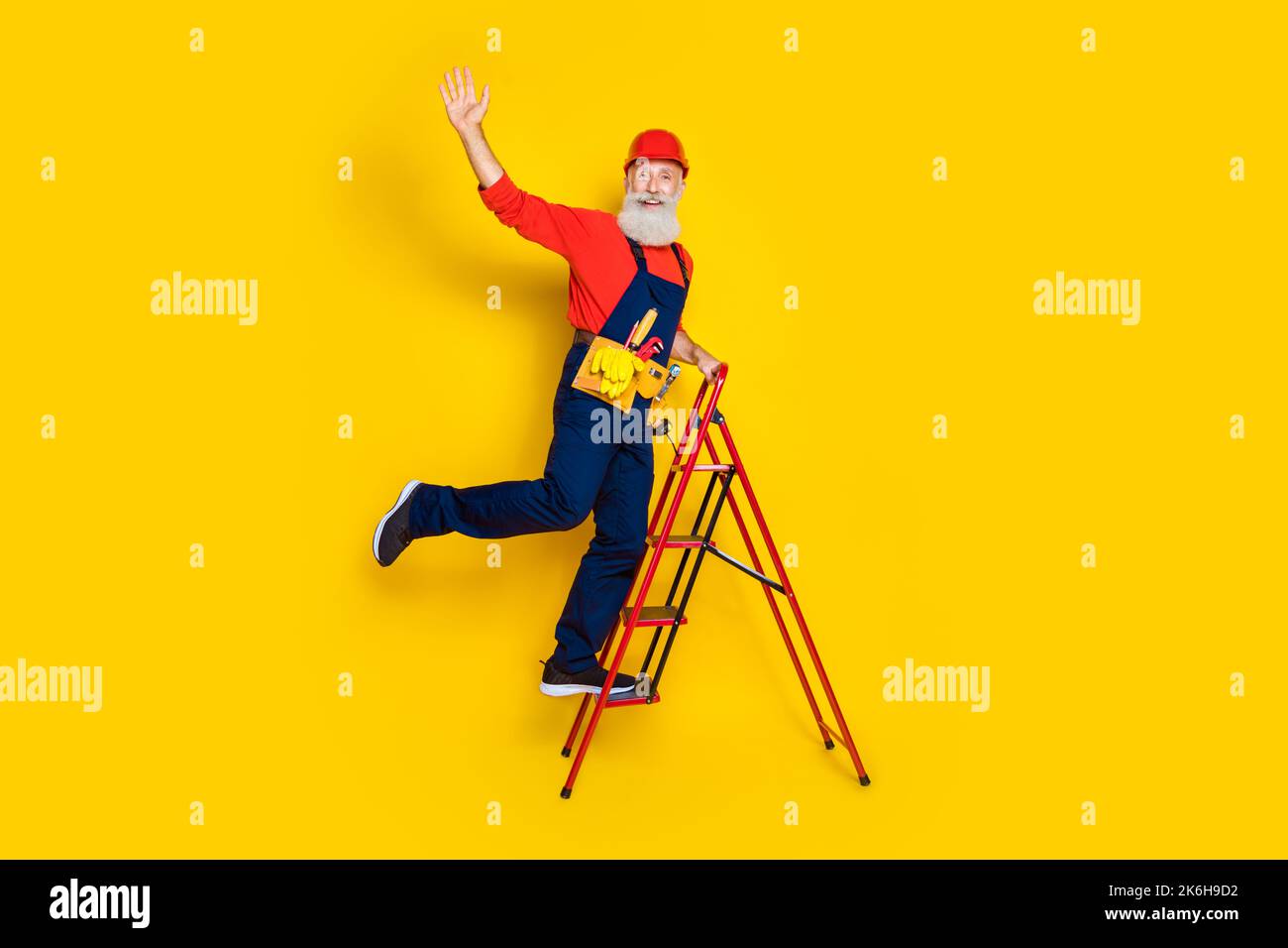 Full length photo of funny positive old guy dressed uniform overall red