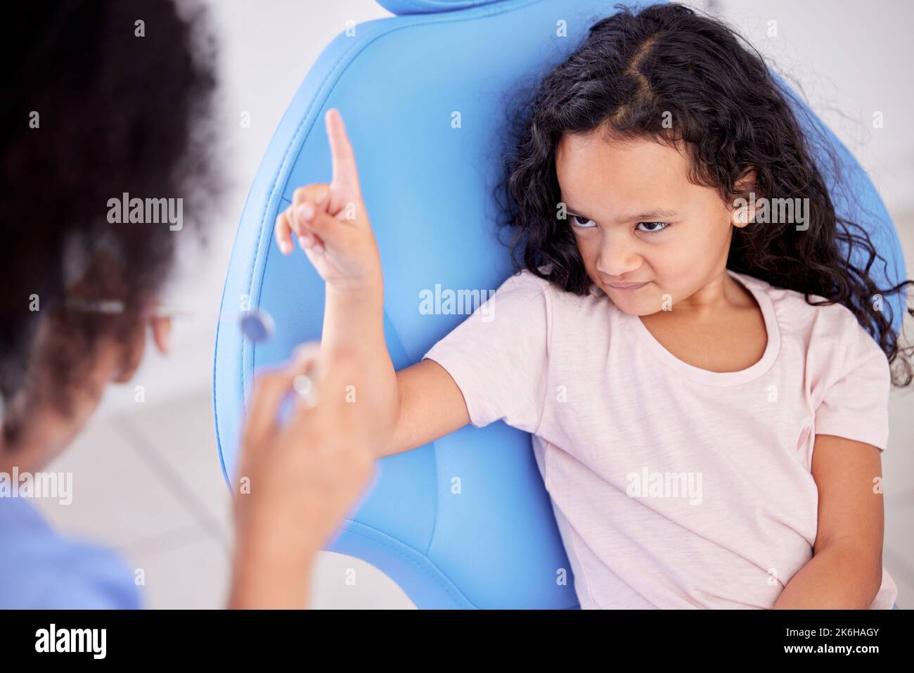 Love conquers all things except poverty and toothache. a little girl looking upset at the dentist. Stock Photo