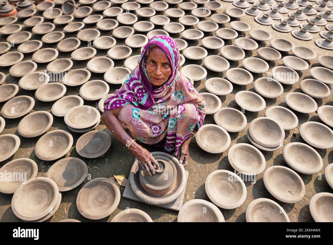 Workers make clay pots as a form of pottery business to sell at a