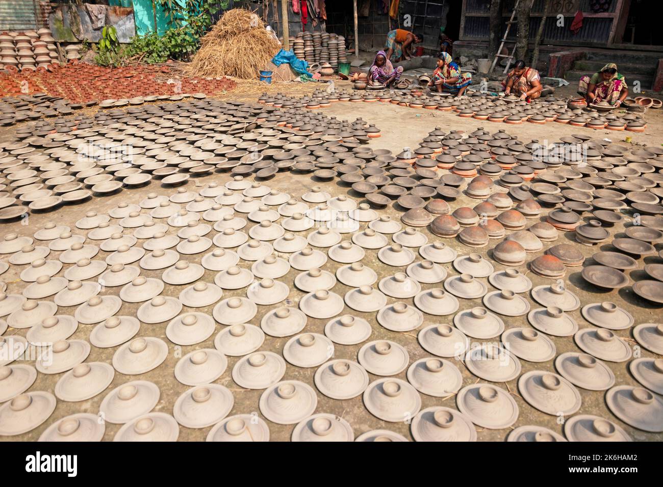Workers make clay pots as a form of pottery business to sell at a
