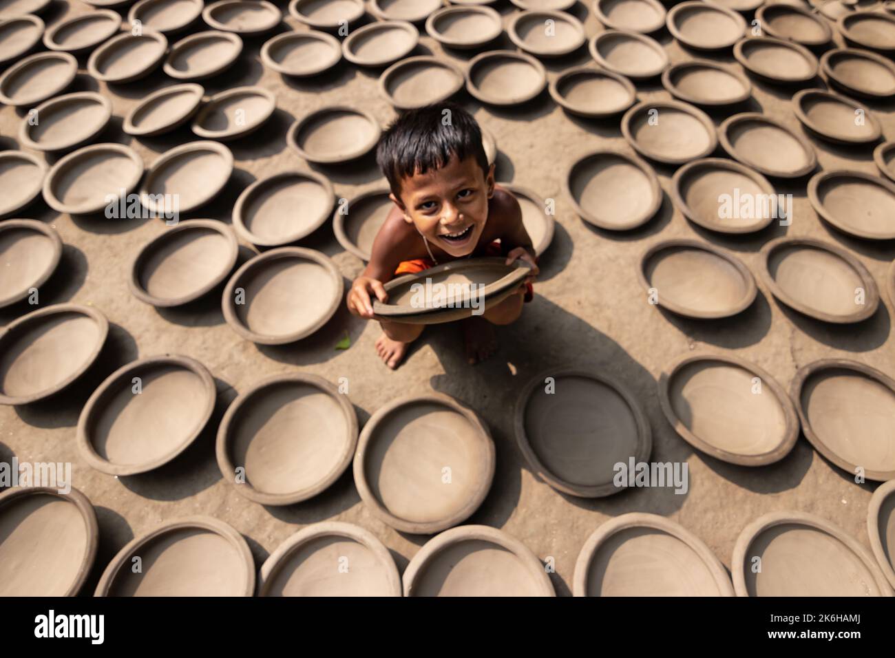 Workers make clay pots as a form of pottery business to sell at a