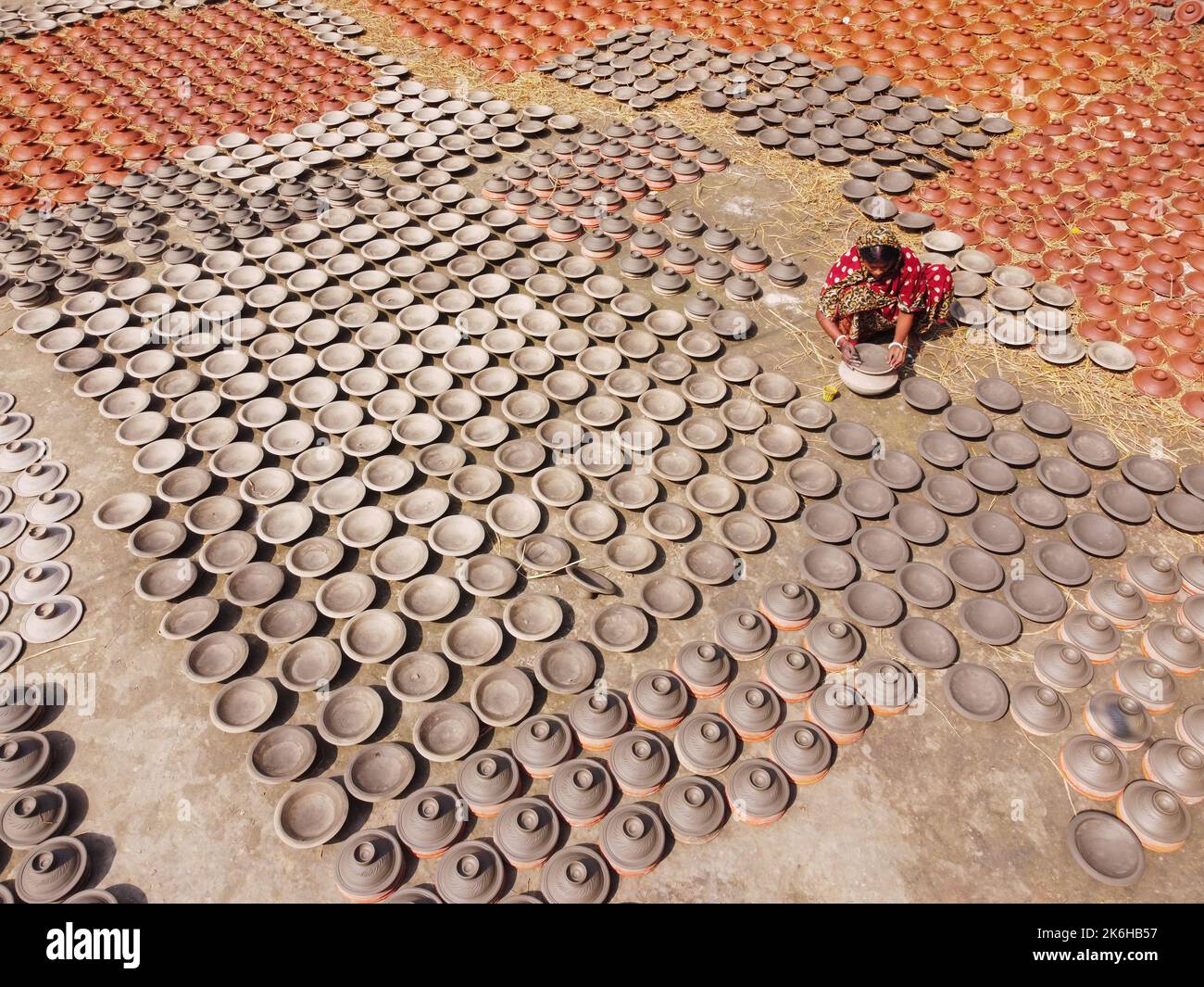 Workers make clay pots as a form of pottery business to sell at a