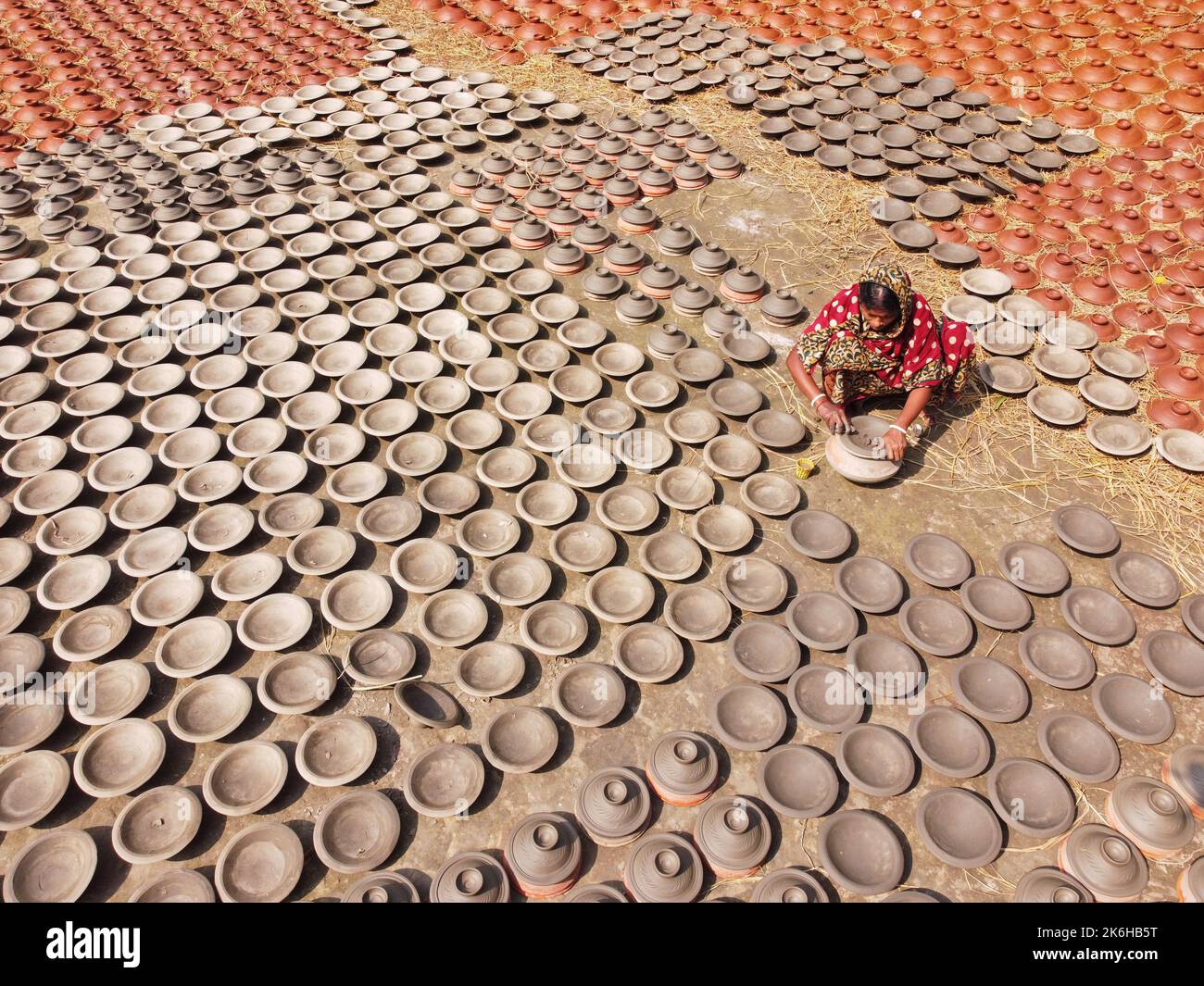 Workers make clay pots as a form of pottery business to sell at a