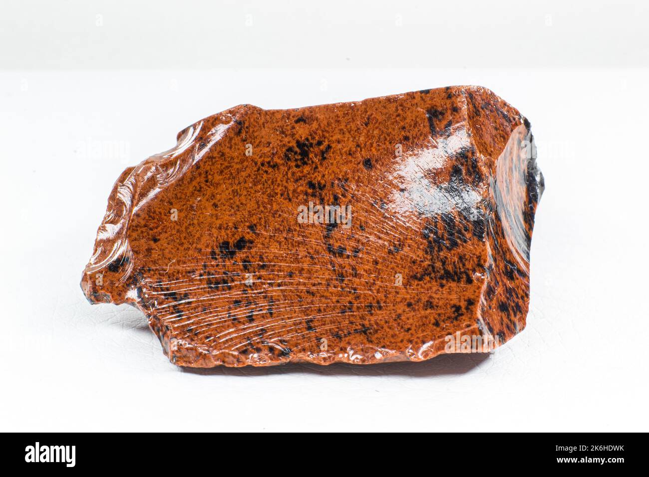 Real shiny specimen of orange Mahogany Obsidian volcanic stone macro isolated on white background Stock Photo