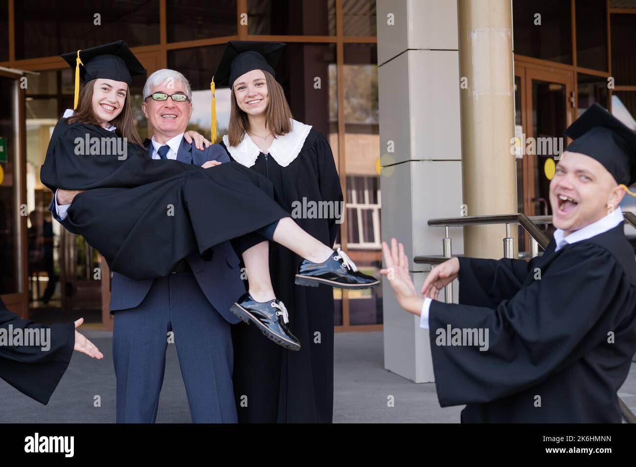 The teacher holds the graduate in his arms Stock Photo Alamy