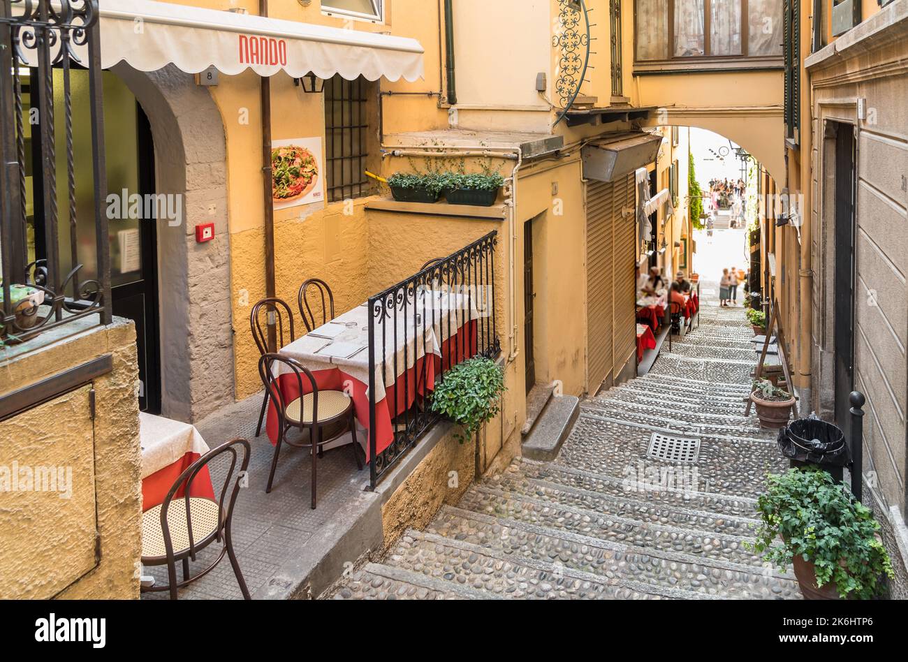 Bellagio, Lombardy, Italy - September 5, 2022: Outdoor cozy street restaurant in the small picturesque village Bellagio on Lake Como. Stock Photo