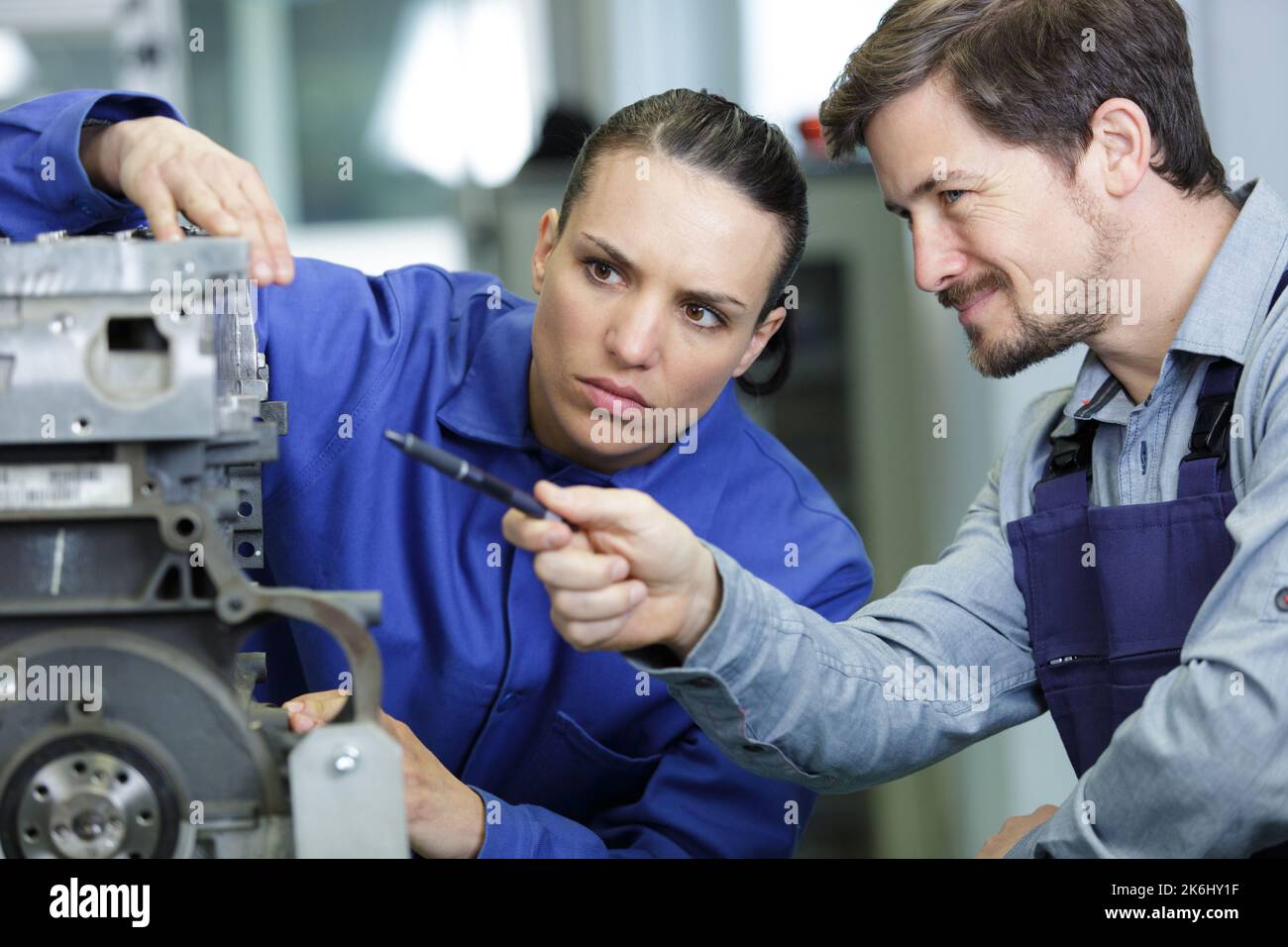 awo mechanics - man and woman examining car engine Stock Photo - Alamy