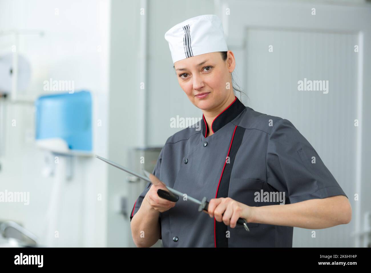 female butcher sharpening the knife Stock Photo Alamy
