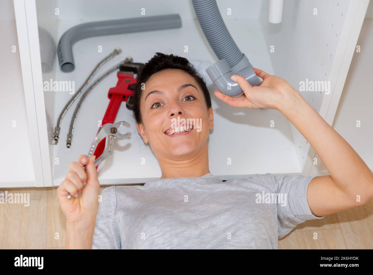girl installing sink drainage system Stock Photo Alamy