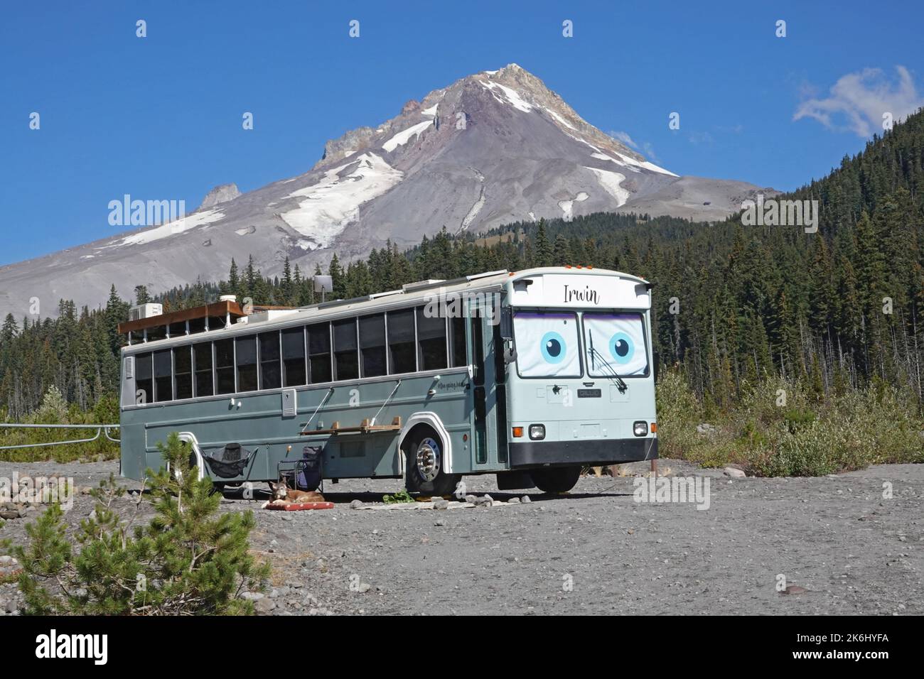 A large bus, turned into a camper, parked at White River Sno Park below Mount Hood, in the Oregon Cascades. Stock Photo