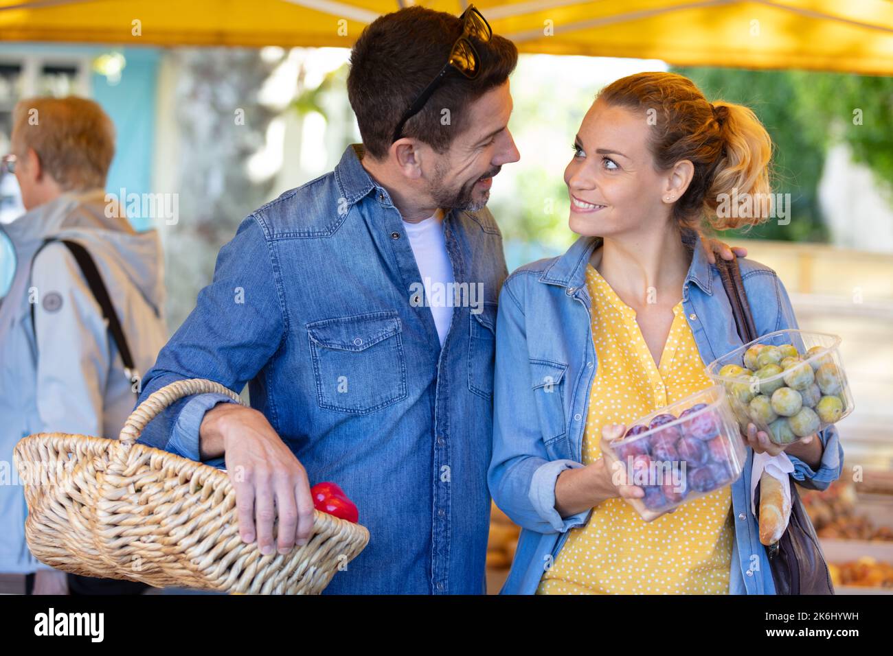 a young couple buying fruits and vegetables in a market Stock Photo - Alamy